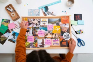 woman decorating vision board
