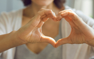woman making a heart with her hands